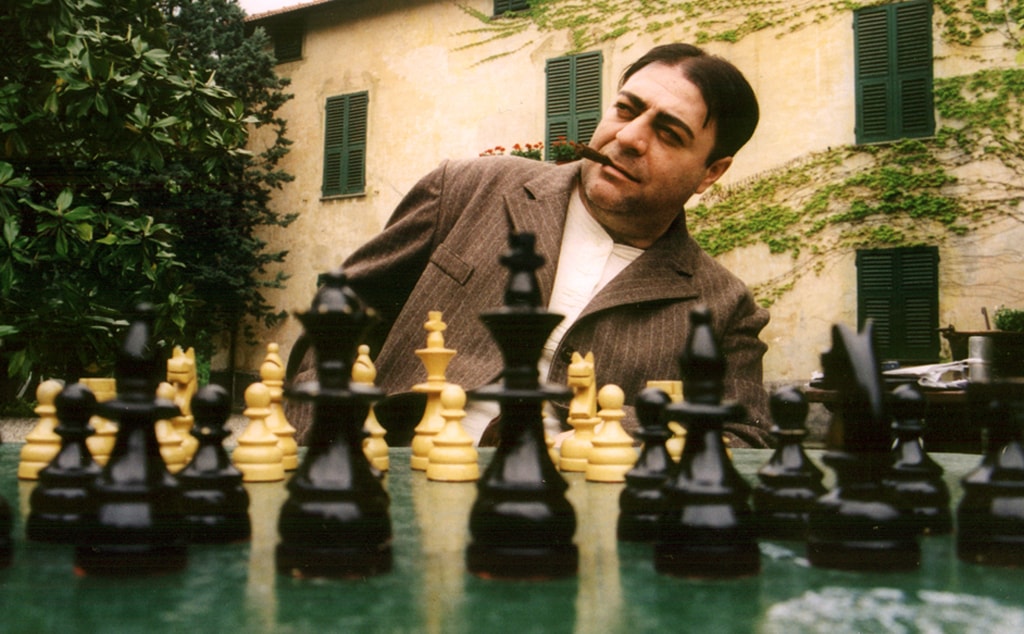 Italian officer playing chess in a courtyard