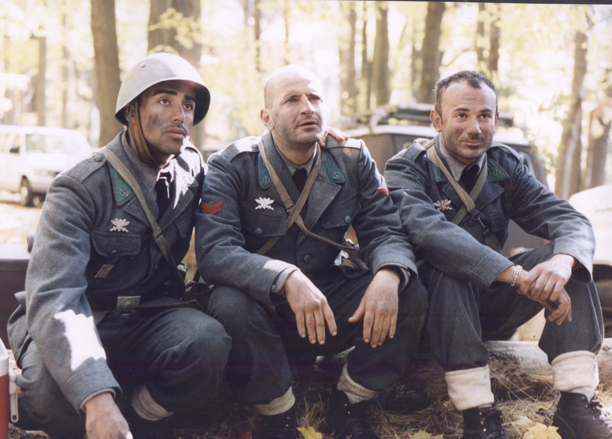 Three Italian soldiers seated together — the Three Marys